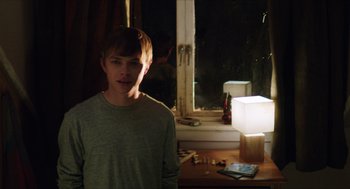 Movie still from “Chronicle” (2012), directed by Josh Trank – A man standing in front of a window at night; Medium shot, Over the shoulder angle