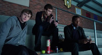 Movie still from “Chronicle” (2012), directed by Josh Trank – A group of young men sitting next to each other on steps; Medium shot, Low angle