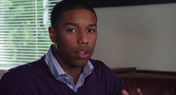 Movie still from “Chronicle” (2012), directed by Josh Trank – A man in a purple shirt is sitting down; Close Up shot, Over the shoulder angle