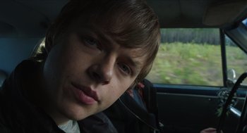 Movie still from “Chronicle” (2012), directed by Josh Trank – A young man sitting in the passenger seat of a car; Close Up shot, Over the shoulder angle