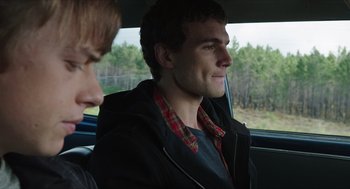 Movie still from “Chronicle” (2012), directed by Josh Trank – A man sitting in the back seat of a car looking out the window; Close Up shot, Over the shoulder angle