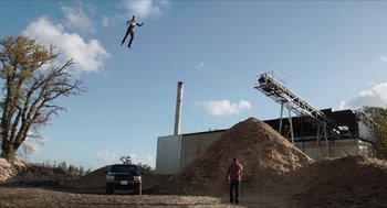 Movie still from “Chronicle” (2012), directed by Josh Trank – A man standing on top of a pile of dirt; Extreme Wide shot, Low angle