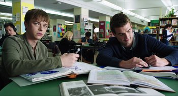 Movie still from “Chronicle” (2012), directed by Josh Trank – Two young men sitting at a table in a library; Medium shot, Over the shoulder angle