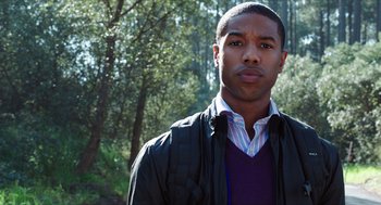 Movie still from “Chronicle” (2012), directed by Josh Trank – A young man standing in a wooded area with trees in the background; Close Up shot, Low angle