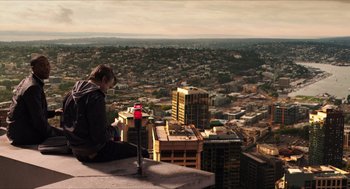 Movie still from “Chronicle” (2012), directed by Josh Trank – A man sitting on top of a building looking at a city; Extreme Wide shot, High angle
