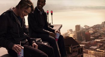 Movie still from “Chronicle” (2012), directed by Josh Trank – A group of people sitting on top of a building next to each other; Medium shot, Over the shoulder angle
