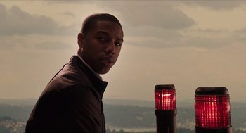 Movie still from “Chronicle” (2012), directed by Josh Trank – A man standing in front of a red light; Close Up shot, Low angle