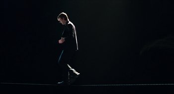 Movie still from “Chronicle” (2012), directed by Josh Trank – A man walking in the dark in a black suit; Wide shot, Low angle