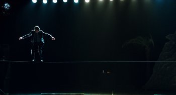 Movie still from “Chronicle” (2012), directed by Josh Trank – A man standing on top of a platform in a dark room; Wide shot, Low angle