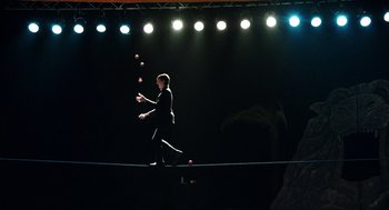 Movie still from “Chronicle” (2012), directed by Josh Trank – A man juggling three balls on a tightrope; Wide shot, Low angle