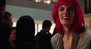 Movie still from “Chronicle” (2012), directed by Josh Trank – A woman with red hair is smiling for the camera; Close Up shot, Over the shoulder angle