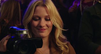 Movie still from “Chronicle” (2012), directed by Josh Trank – A beautiful blonde woman with a camera; Close Up shot, Over the shoulder angle