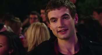 Movie still from “Chronicle” (2012), directed by Josh Trank – A young man smiling for the camera at a party; Close Up shot, Over the shoulder angle