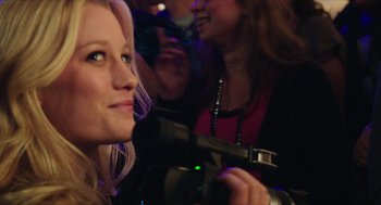 Movie still from “Chronicle” (2012), directed by Josh Trank – A woman is holding a video camera up to her face; Close Up shot, Over the shoulder angle