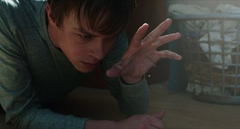 Movie still from “Chronicle” (2012), directed by Josh Trank – A young man is laying on the floor with his hands in the air; Close Up shot, High angle
