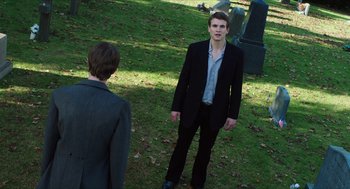 Movie still from “Chronicle” (2012), directed by Josh Trank – A man in a suit and tie standing next to another man in a suit and tie; Wide shot, Over the shoulder angle