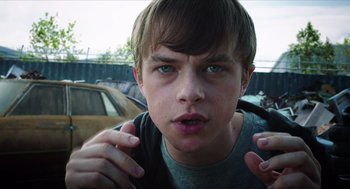 Movie still from “Chronicle” (2012), directed by Josh Trank – A young man is holding his hands up to his face; Close Up shot, Low angle