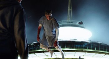 Movie still from “Chronicle” (2012), directed by Josh Trank – A man in a hospital gown is jumping in the air; Wide shot, Low angle