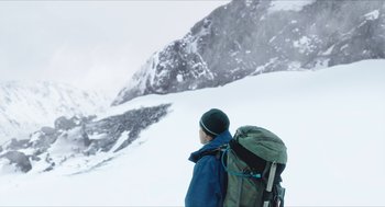 Movie still from “Chronicle” (2012), directed by Josh Trank – A man with a backpack standing on a snowy mountain; Wide shot, Low angle