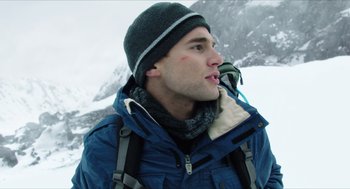 Movie still from “Chronicle” (2012), directed by Josh Trank – A man in a blue jacket and a black hat is in the snow; Close Up shot, Low angle