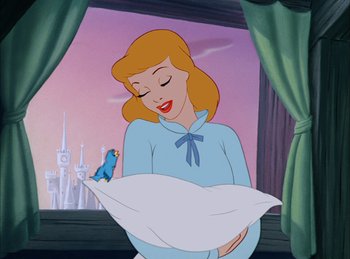 Movie still from “Cinderella” (1950), directed by Hamilton Luske – A woman holding onto a pillow with a bird sitting on top of it; Medium shot, Over the shoulder angle