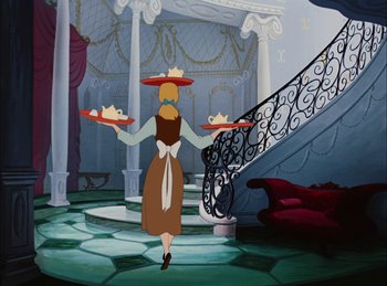 Movie still from “Cinderella” (1950), directed by Hamilton Luske – A woman walking down the stairs holding two plates of food; Wide shot, Overhead angle