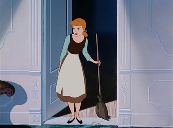 Movie still from “Cinderella” (1950), directed by Hamilton Luske – A woman standing in front of an open door holding a broom; Wide shot, High angle