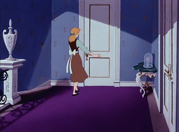 Movie still from “Cinderella” (1950), directed by Hamilton Luske – A woman standing in front of a door in a room; Wide shot, High angle