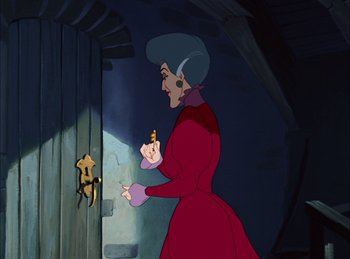 Movie still from “Cinderella” (1950), directed by Hamilton Luske – An old woman in a red dress is looking at a baby; Medium shot, Over the shoulder angle