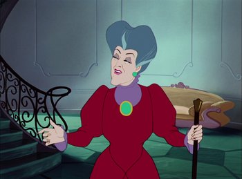 Movie still from “Cinderella” (1950), directed by Hamilton Luske – A woman in a red dress is holding a cane; Medium shot, Over the shoulder angle