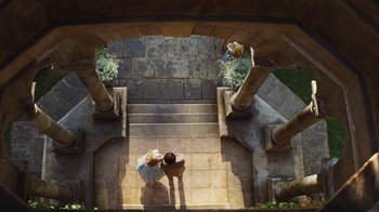 Movie still from “Cinderella” (2015), directed by Kenneth Branagh – Two people standing on a set of stairs; Extreme Wide shot, Overhead angle