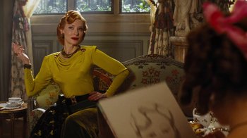 Movie still from “Cinderella” (2015), directed by Kenneth Branagh – A woman sitting on a couch in front of a painting; Medium shot, Over the shoulder angle
