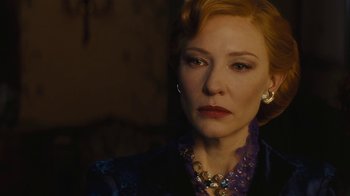 Movie still from “Cinderella” (2015), directed by Kenneth Branagh – A person wearing a suit and a necklace; Close Up shot, Over the shoulder angle