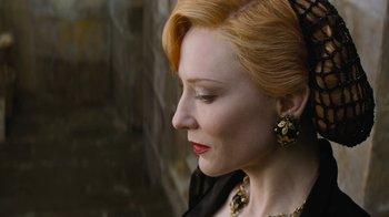 Movie still from “Cinderella” (2015), directed by Kenneth Branagh – A person with red hair wearing a necklace; Close Up shot, Over the shoulder angle
