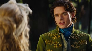 Movie still from “Cinderella” (2015), directed by Kenneth Branagh – A man in a green jacket standing in front of a white sheep; Close Up shot, Over the shoulder angle
