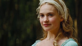 Movie still from “Cinderella” (2015), directed by Kenneth Branagh – A young woman with blonde long hair and a white head scarf; Close Up shot, Over the shoulder angle