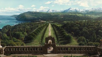 Movie still from “Cinderella” (2015), directed by Kenneth Branagh – An aerial view of a park with trees and mountains in the background; Extreme Wide shot, High angle