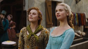 Movie still from “Cinderella” (2015), directed by Kenneth Branagh – Two women standing next to each other on a street; Medium shot, Low angle