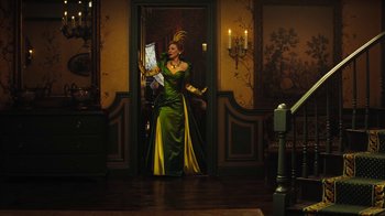 Movie still from “Cinderella” (2015), directed by Kenneth Branagh – A woman in a green dress standing in front of a door; Wide shot, Low angle