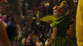 Movie still from “Cinderella” (2015), directed by Kenneth Branagh – A woman in a green dress holding an umbrella; Medium shot, Over the shoulder angle