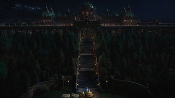 Movie still from “Cinderella” (2015), directed by Kenneth Branagh – A man sitting on top of a staircase at night; Extreme Wide shot, High angle