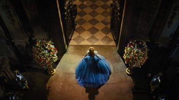 Movie still from “Cinderella” (2015), directed by Kenneth Branagh – A woman in a blue dress standing in a doorway; Wide shot, Overhead angle