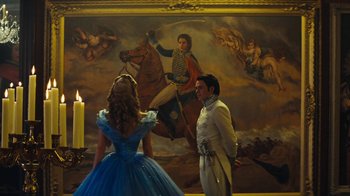 Movie still from “Cinderella” (2015), directed by Kenneth Branagh – A man and a woman dressed as cinderella and prince charming in front of a painting; Wide shot, Low angle