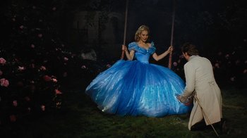 Movie still from “Cinderella” (2015), directed by Kenneth Branagh – A woman in a blue dress swinging on a swing; Wide shot, High angle