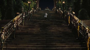 Movie still from “Cinderella” (2015), directed by Kenneth Branagh – A man standing on some steps in front of a group of people; Extreme Wide shot, High angle
