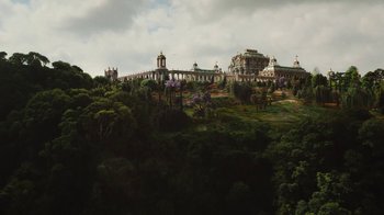 Movie still from “Cinderella” (2015), directed by Kenneth Branagh – A large building on top of a hill with trees around it; Extreme Wide shot, Low angle
