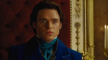 Movie still from “Cinderella” (2015), directed by Kenneth Branagh – A man in a blue jacket and a blue neck tie; Close Up shot, Over the shoulder angle