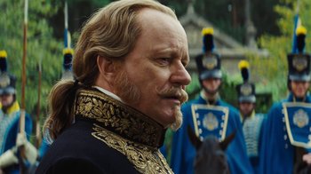 Movie still from “Cinderella” (2015), directed by Kenneth Branagh – A person wearing a suit and tie; Close Up shot, Over the shoulder angle