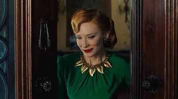 Movie still from “Cinderella” (2015), directed by Kenneth Branagh – A woman in a green dress and a gold necklace; Close Up shot, Over the shoulder angle