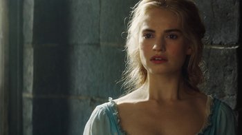 Movie still from “Cinderella” (2015), directed by Kenneth Branagh – A beautiful young woman with blonde hair wearing a blue dress; Close Up shot, Over the shoulder angle